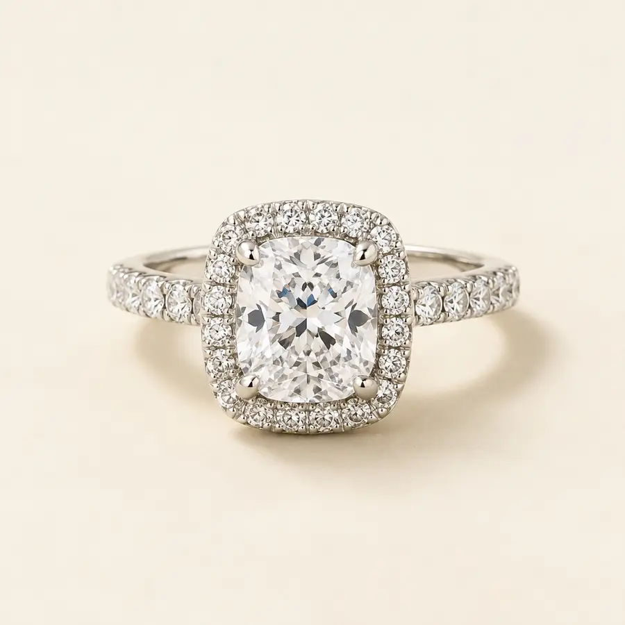 Cushion cut diamond halo engagement ring with a pavé band in white gold